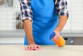Man cleaning table with rag in kitchen Royalty Free Stock Photo