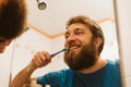 Man cleaning teeth in bathroom