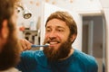 Man cleaning teeth in bathroom