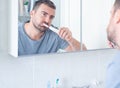 Man cleaning teeth using an electric toothbrush Royalty Free Stock Photo