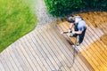 man cleaning terrace with a power washer - high water pressure c