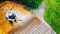 man cleaning terrace with a power washer - high water pressure c