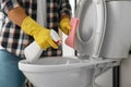 Man cleaning toilet bowl in bathroom Royalty Free Stock Photo