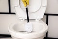 Man cleaning toilet bowl in bathroom Royalty Free Stock Photo