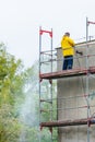 Man cleaning wall. Scaffolding Royalty Free Stock Photo