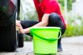 Man cleaning wheel rim while car wash