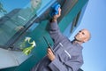 Man cleaning window in office