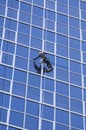 Man cleaning windows of modern business building Royalty Free Stock Photo