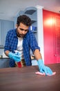 Man cleaning wooden table Royalty Free Stock Photo