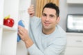 Man cleans cupboards Royalty Free Stock Photo