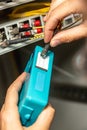 A man cleans the fiber optic cable connectors with a special blue cleaner. Cleaning connectors close up against the Royalty Free Stock Photo