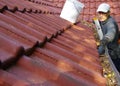 The man cleans the gutters on the roof Royalty Free Stock Photo