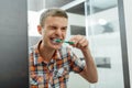 Man cleans his teeth in the bathroom Royalty Free Stock Photo