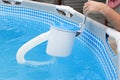 Man cleans skimmer for the frame pool. Contaminated pool cleaning concept Royalty Free Stock Photo