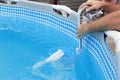 Man cleans skimmer for the frame pool. Contaminated pool cleaning concept Royalty Free Stock Photo