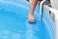 Man cleans skimmer for the frame pool. Contaminated pool cleaning concept Royalty Free Stock Photo