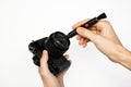 A man cleans a SLR camera with a brush Royalty Free Stock Photo