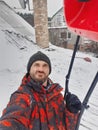 A man cleans snow on a roof with a snow shovel