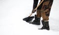 A man cleans snow with a shovel. The dusting of snow. Close up Royalty Free Stock Photo