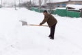 Man cleans snow shovel Royalty Free Stock Photo