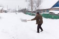 Man cleans snow shovel Royalty Free Stock Photo