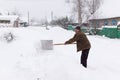 Man cleans snow shovel Royalty Free Stock Photo