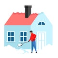 a man cleans snow with a shovel near his house Royalty Free Stock Photo