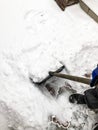 Man cleans snow in the winter in his yard near the house Royalty Free Stock Photo