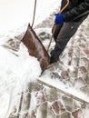 Man cleans snow in the winter in his yard near the house Royalty Free Stock Photo