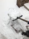 Man cleans snow in the winter in his yard near the house Royalty Free Stock Photo