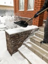 Man cleans snow in the winter in his yard near the house Royalty Free Stock Photo