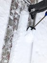 Man cleans snow in the winter in his yard near the house Royalty Free Stock Photo