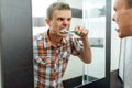 Man cleans teeth in the bathroom Royalty Free Stock Photo