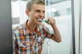 Man cleans teeth in the bathroom Royalty Free Stock Photo