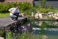 Man cleanse his garden pond