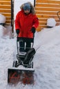 A man clear snow from backyard with snow blower. Winter season and snow blower equipment