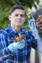 Man Clearing Leaves From Guttering Of House Royalty Free Stock Photo