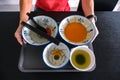 Man clearing tray of used crockery after dining. Diners at coffee shops, food courts are expected to clear their tables, dirty