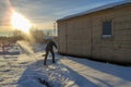 a man clears snow with a shovel
