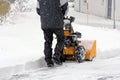 Man clears snow with a snow mill