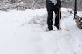 Man clears in winter snow from a footpath Royalty Free Stock Photo