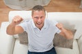 Man Clenching Fist On Sofa