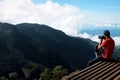 Man on the cliff edge photographing nature.