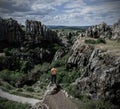 Man on cliff edge in rocky mountains