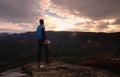 Man on a cliff edge on top of mountain with gorgeous view Royalty Free Stock Photo