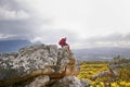 Man, cliff and relax on outdoor hike in nature, mountain and peace or calm on rocks for wellness. Male person, exercise Royalty Free Stock Photo