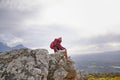 Man, cliff and thinking on outdoor hike in nature, mountain and peace or calm on rocks for wellness. Person, exercise Royalty Free Stock Photo