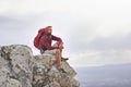Man, cliff and thoughts on outdoor hike in nature, mountain and peace or calm on rocks for wellness. Male person Royalty Free Stock Photo