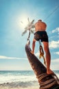 Man climb on palm tree for swing on the beach swing Royalty Free Stock Photo