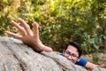 Man climb rock in the forest and hand for help